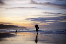 Rick Wellington and Poppy prepare for a mad session with the ball at Middle Beach, Dunedin, New Zealand. 