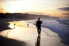 Rick Wellington and Poppy prepare for a mad session with the ball at Middle Beach, Dunedin, New Zealand. 