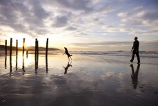 Rick Wellington and Poppy prepare for a mad session with the ball at Middle Beach, Dunedin, New Zealand. 