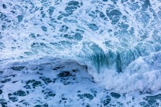 Waves break on the shore during a large winter swell at St Clair, Dunedin, New Zealand. 