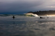 Surfers stalk the peak on a small day at St Kilda, Dunedin, New Zealand.