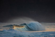 Clean hollow waves on dusk at St Kilda, Dunedin, New Zealand.