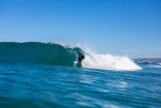 Graham Carse all smiles as he pulls into a barrel in clean glassy waves at Blackhead, Dunedin, New Zealand.