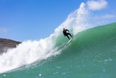Local surfer Jake turns off the top on a big wave at Raglan, Waikato, New Zealand.