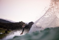 Raglan surfboard shaper Luke Hughes at home on a dusk wave at Manu Bay, Raglan, Waikato, New Zealand.