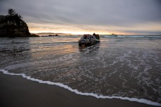 Tow surfers prepare for a session on a  reefbreak in the South Island, New Zealand.