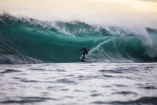 Dave Lyons lines up a barrel on a slabbing reefbreak in the South Island, New Zealand.