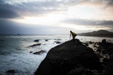 Taya lines up a shot as a storm front bears down on St Clair, Dunedin, New Zealand. 