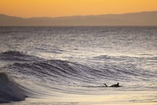 A surfer stalks a wave in the afternoon light at Blackhead, Dunedin, New Zealand.
Credit: www.boxoflight.com/Derek Morrison