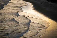 Sunset as summer waves roll in at Blackhead, Dunedin, New Zealand.