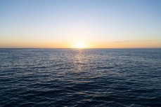Sunrisde and a gentle sea state during a Heritage Expeditions voyage to the Sub-Antarctic Islands, New Zealand.