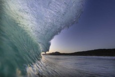 A wave breaks on dusk at Blackhead, Dunedin, New Zealand.