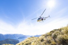 Southern Lakes Helicopters ferry guests to a mountain peak during a Heritage Expeditions voyage to Dusky Sound in Fiordland, New Zealand.