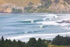 A large swell hits a reef break near Dunedin, New Zealand.