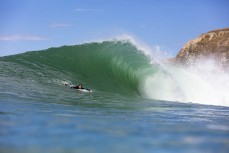 Lorne Secord paddles inas a large swell hits near Dunedin, New Zealand.