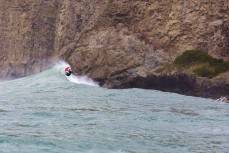 Jamie Civil on point as a large swell hits near Dunedin, New Zealand.