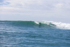 Reuben Lyons rides a large swell at a point break near Dunedin, New Zealand.