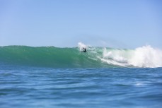 Doug Young makes the most of a large swell at a point break near Dunedin, New Zealand.