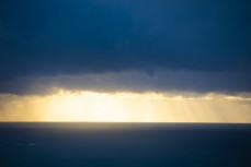 Dawn light pierces through a heavy cloud blanket at St Clair, Dunedin, New Zealand.
Credit: www.boxoflight.com/Derek Morrison