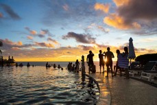 Single Fin partygoers watching the sunset over Uluwatu, Bali, Indonesia.