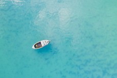A small boat moored in a small bay on Otago Harbour, Dunedin, New Zealand. 