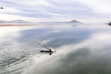 Keo (9) paddles across the rivermouth after a small winter session at Karitane, Dunedin, New Zealand.Credit: www.boxoflight.com/Derek Morrison