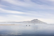 Craig and Jack Higgins paddle across the rivermouth after a small winter session at Karitane, Dunedin, New Zealand.Credit: www.boxoflight.com/Derek Morrison