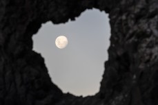 Full moon through a hole in a rock on the north coast of Dunedin, New Zealand.Credit: www.boxoflight.com/Derek Morrison