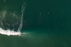 A surfer takes off on a wave at Blackhead, Dunedin, New Zealand.