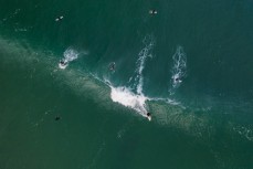 A surfer takes off on a wave at Blackhead, Dunedin, New Zealand.