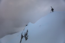 Katie Duffy hikes a peak in thick fog at Rainbow Ski Area near Nelson, Tasman, New Zealand.