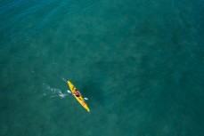 Clive Paul paddles out into Cable Bay on a beautiful day in Tasman, New Zealand. 