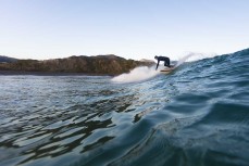Jason Newton working down the line in fun waves at Blackhead Beach, Dunedin, New Zealand.