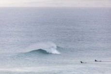 Surfers make the most of a small spring swell at Blackhead, Dunedin, New Zealand. 