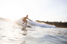 Talia, 11, skiprs school for some surf coaching at Sandy Bay, Tutukaka Coast, Northland, New Zealand.
