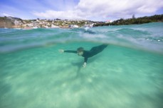 Jimmy Higgins dives beneath the water at St Clair, Dunedin, New Zealand.