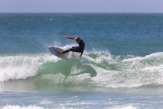 Nixon Reardon on form during a warm summery afternoon in fun waves at Aramoana, Dunedin, New Zealand.