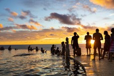 People gather to watch the sunset at the Single Fin at Uluwatu, Bali, Indonesia.