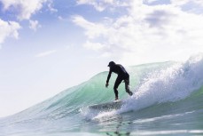 Phil Erickson rides a wave at dawn at a beachbreak near Gisborne, Eastland, New Zealand.