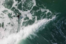 Bobby Hansen rides a wave at a beachbreak near Gisborne, Eastland, New Zealand.