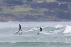 Keo and Jimi share a wave during a fun swell at a beach on the North Coast, Dunedin, New Zealand.Credit: www.boxoflight.com/Derek Morrison