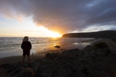 Keo Morrison, 10, checks the surf at dawn at Sumner Beach, Christchurch, Canterbury, New Zealand. 
