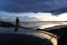 Keo watches the sun set over late autumn waves at Blackhead, Dunedin, New Zealand.
Credit: www.boxoflight.com/Derek Morrison