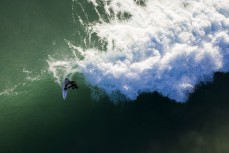 A surfer makes the most of a fun swell as it wraps into the North Coast, Dunedin, New Zealand.Credit: www.boxoflight.com/Derek Morrison