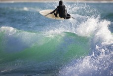 A surfer goes to the air as a fun swell wraps into the North Coast, Dunedin, New Zealand.
Credit: www.boxoflight.com/Derek Morrison