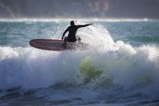 A longboarder cranks off the top during a fun swell on the North Coast, Dunedin, New Zealand.Credit: www.boxoflight.com/Derek Morrison