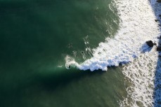 A surfer makes the most of a fun swell as it wraps into the North Coast, Dunedin, New Zealand.Credit: www.boxoflight.com/Derek Morrison
