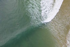 A surfer rides a wave during a rare swell on the North Coast, Dunedin, New Zealand. Photo: Derek Morrison