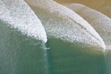 A surfer rides a wave during a rare swell on the North Coast, Dunedin, New Zealand. Photo: Derek Morrison