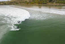 Keo (11) and Jack (10) share a party wave during a rare swell on the North Coast, Dunedin, New Zealand. Photo: Derek Morrison